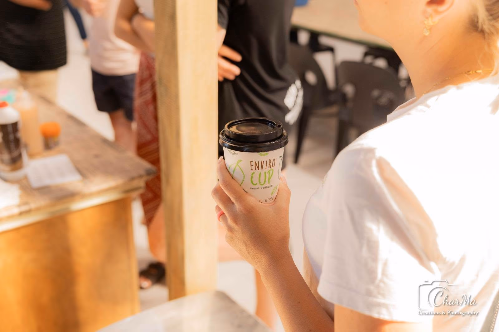 A visitor enjoying takeaway coffee at Barefoot Market