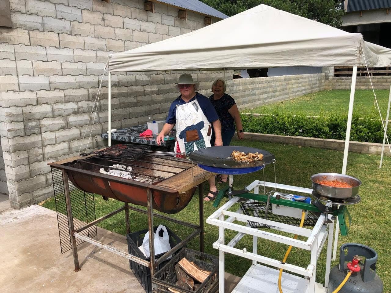 Food being prepared over an outdoor fire at Barefoot Market