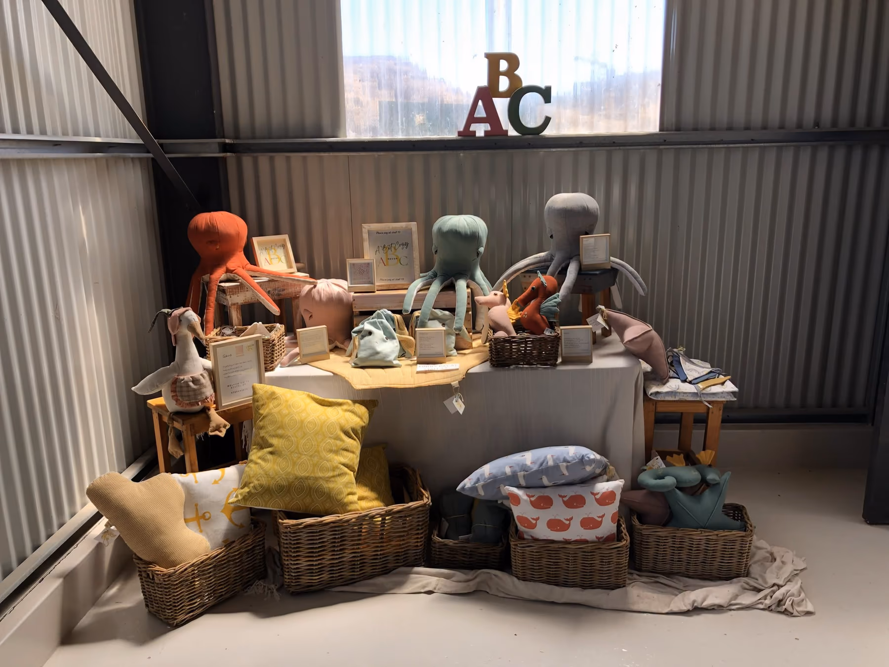 A colourful display of handmade children's toys at the market
