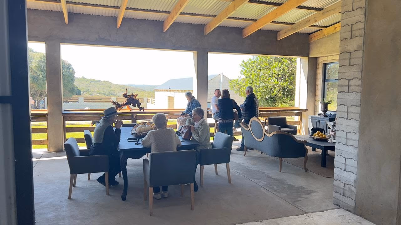 Guests sharing a relaxed morning on Barefoot Market's covered veranda